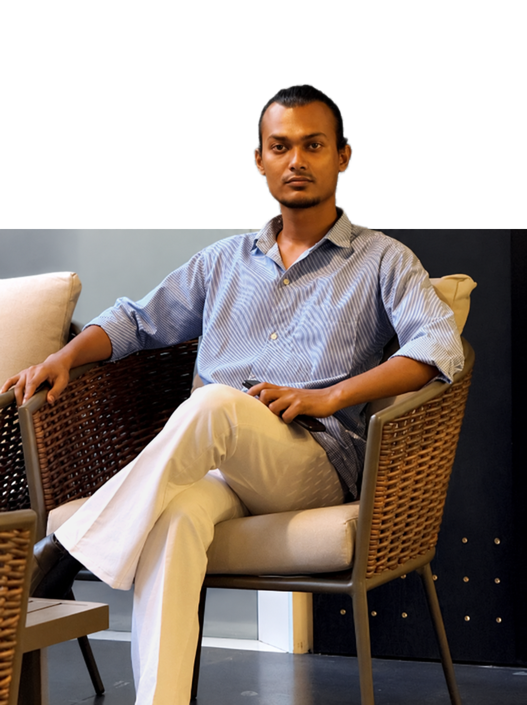 MD. Hasibul Hasan seated on a chair